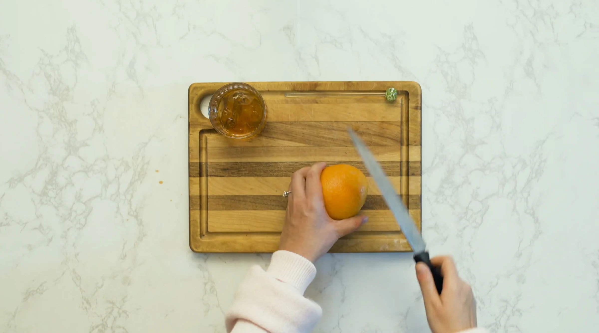 Hands slicing a lemon on a marble counter, from the short film A Holiday Casserole, where Katie Peabody played Brianne