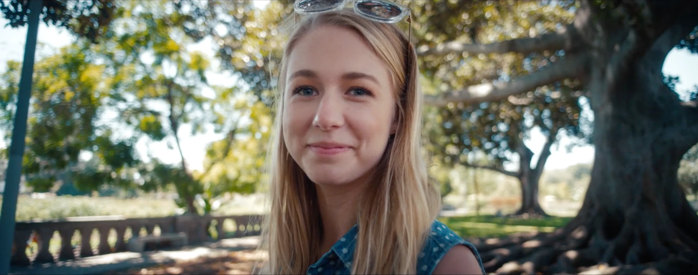 Katie Peabody in the music video for Blue Room by Alex Bloom, holding an infant in soft light