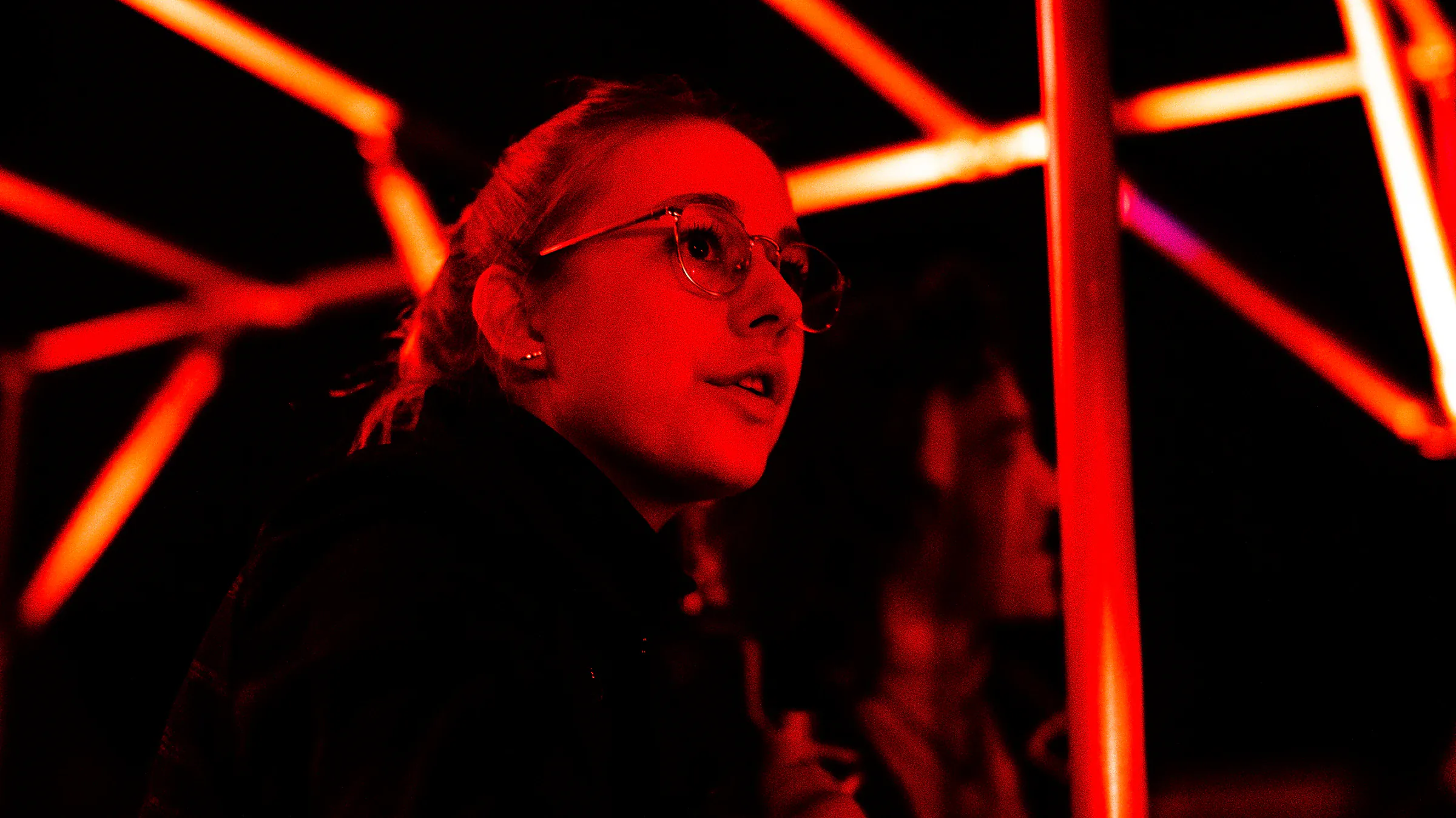 Katie Peabody as Vi lit in red neon, from the documentary Everyone Agrees