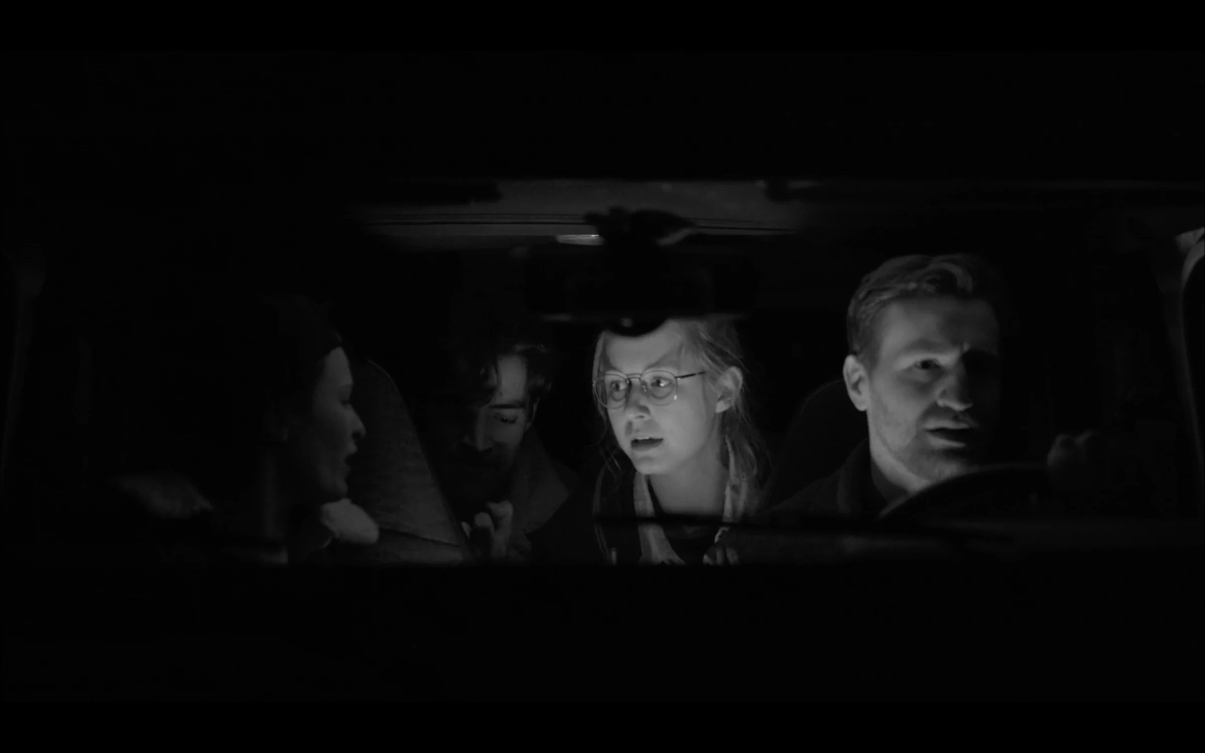 Four young people lit by a screen in a dark room, from the short film Friendship Is a Grenade, where Katie Peabody played Sister