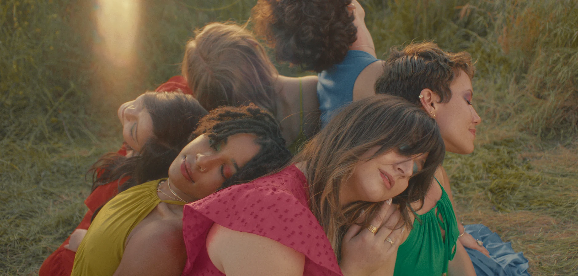 A group lying together on the grass in the short film Grace's Gospel