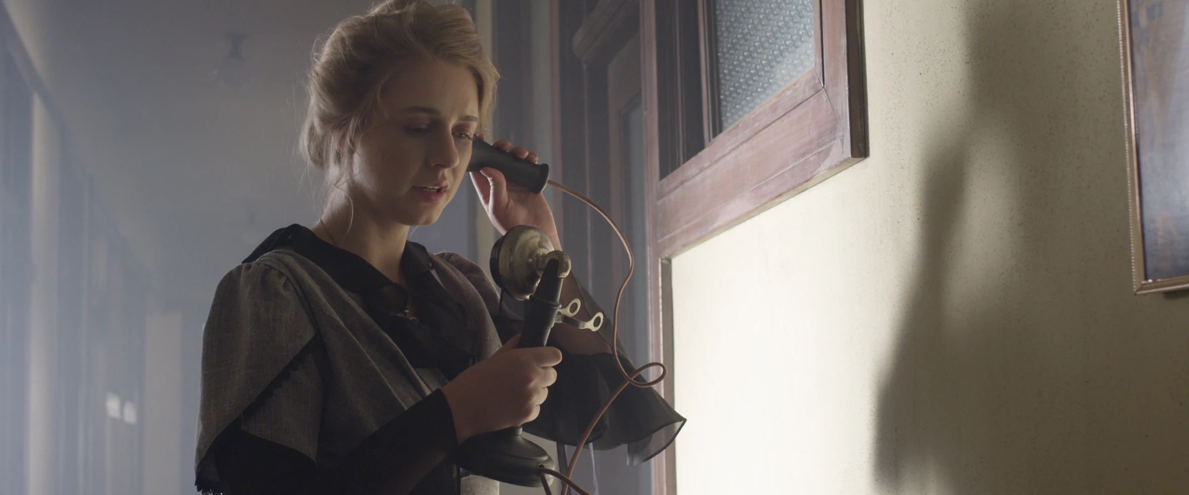 Katie Peabody as Josephine in the feature film Krampus Origins, speaking into a telephone receiver