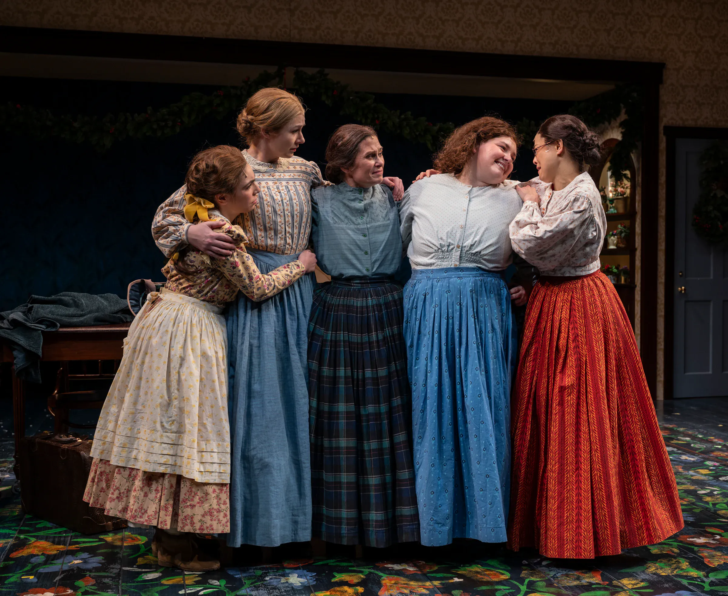 The cast of Little Women at Milwaukee Repertory Theater in period dress, Katie Peabody as Beth March among the sisters