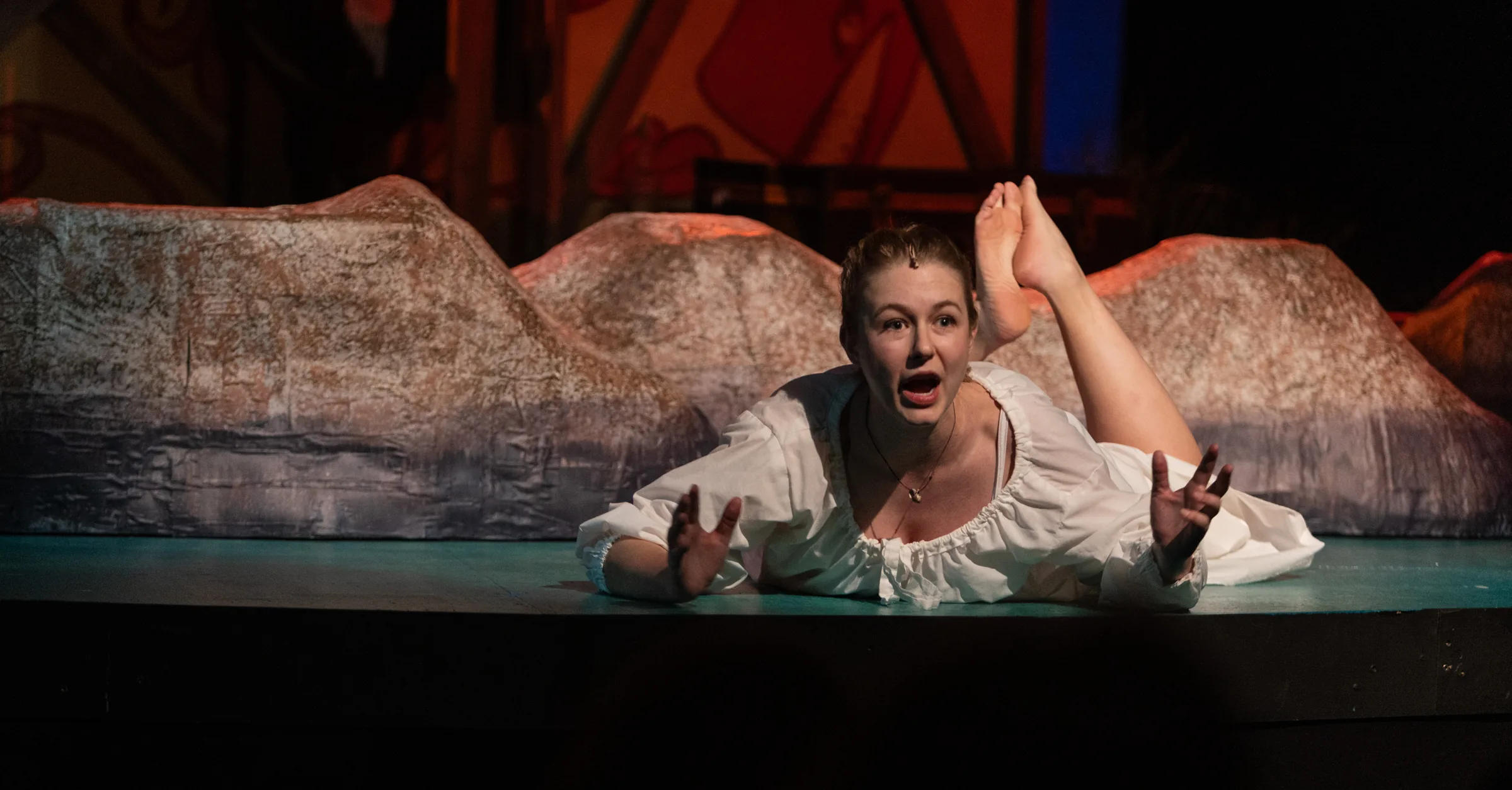 Katie Peabody as Abigail Burgess in Matinicus: A Lighthouse Play, arms outstretched against the lighthouse rigging