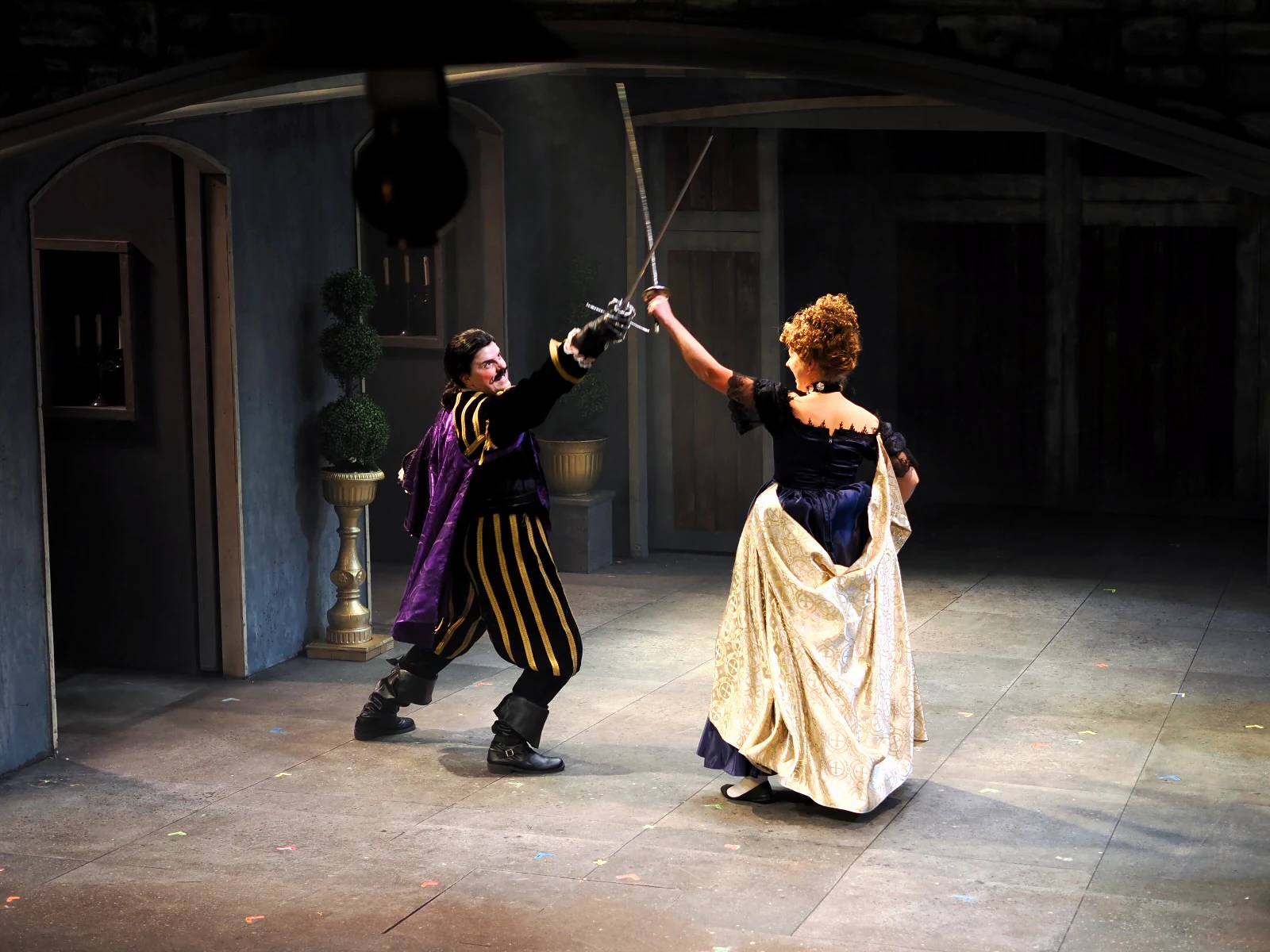 A duel on stage in The Three Musketeers at Sierra Repertory Theater, Katie Peabody in a gold gown crossing swords